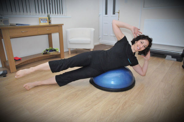 Woman side on stability ball